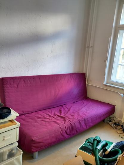 The aforementioned foldable couch in the corner of my (ex-)room.
The cover has a nice reddish purple (it can use a wash, but is otherwise fine)